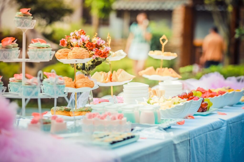 pexels-photo-587741 A vibrant outdoor buffet table showcasing an array of colorful pastries and fruits, perfect for parties.